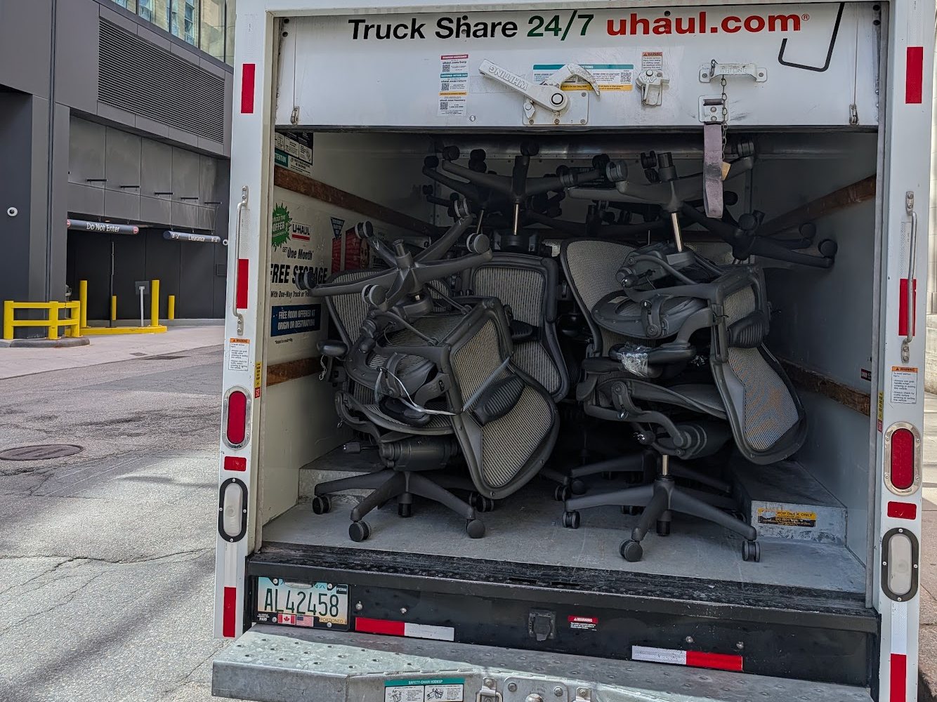 Fifty Herman Miller Aeron chairs loaded in a box truck outside 200 Clarendon Street in Boston
